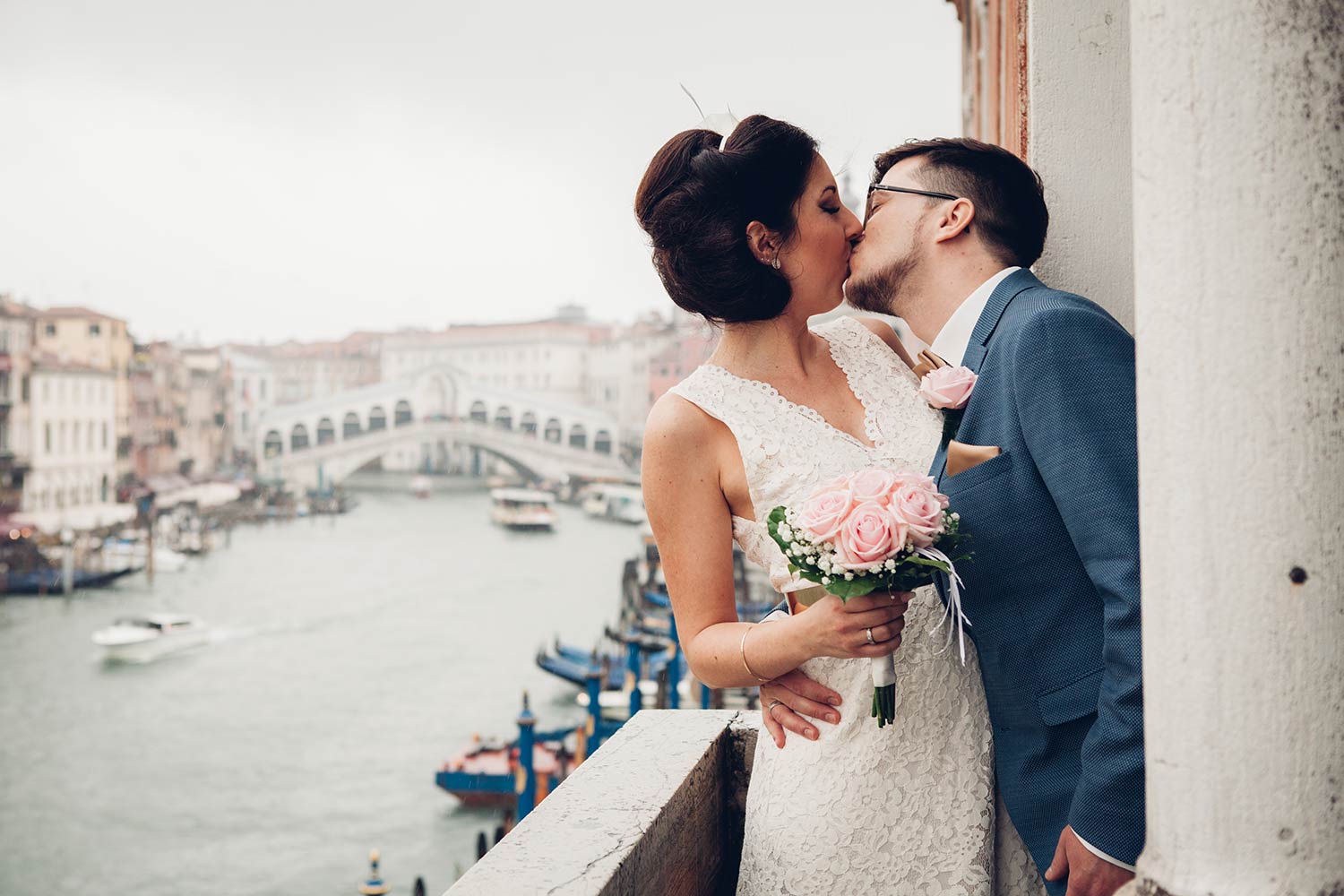 Bride and groom kissing after the wedding in Venice